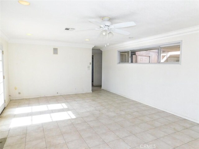 empty room featuring ceiling fan and ornamental molding