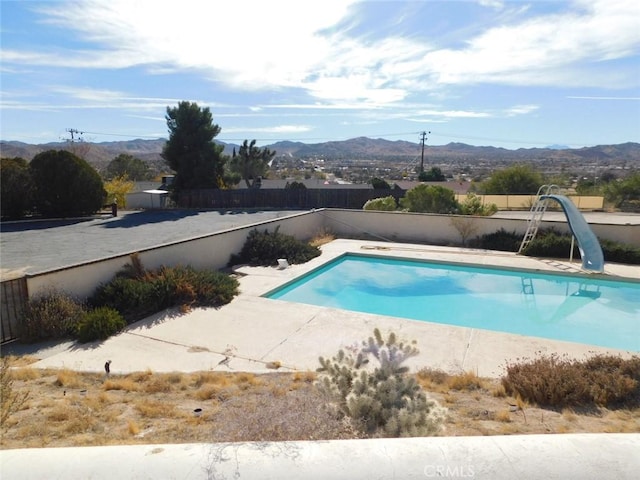 view of swimming pool featuring a mountain view and a water slide