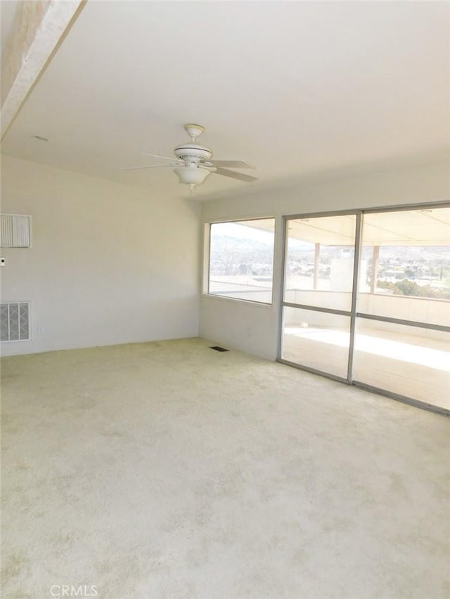 carpeted empty room with ceiling fan