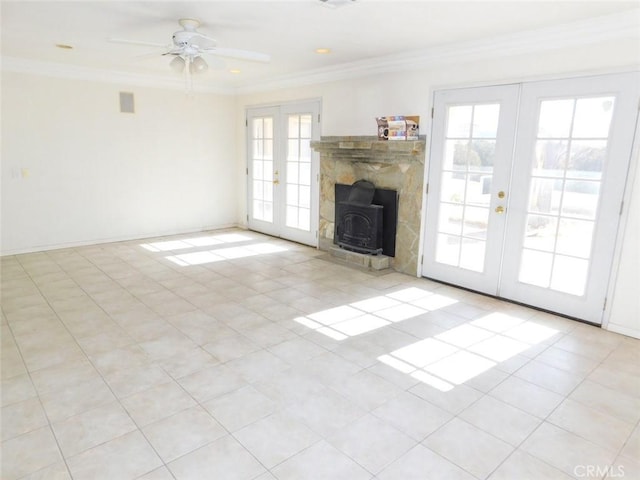 unfurnished living room featuring french doors, ornamental molding, and plenty of natural light