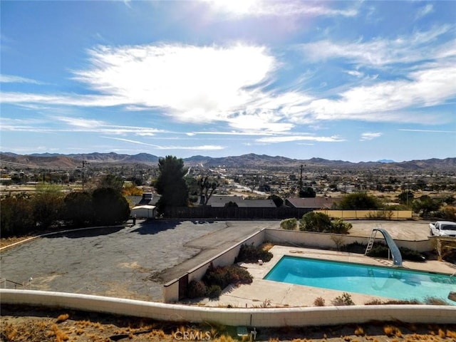 view of pool with a mountain view and a water slide