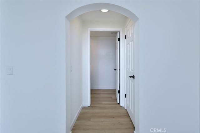 corridor with light hardwood / wood-style floors