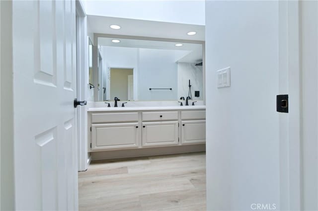 bathroom featuring hardwood / wood-style floors and vanity