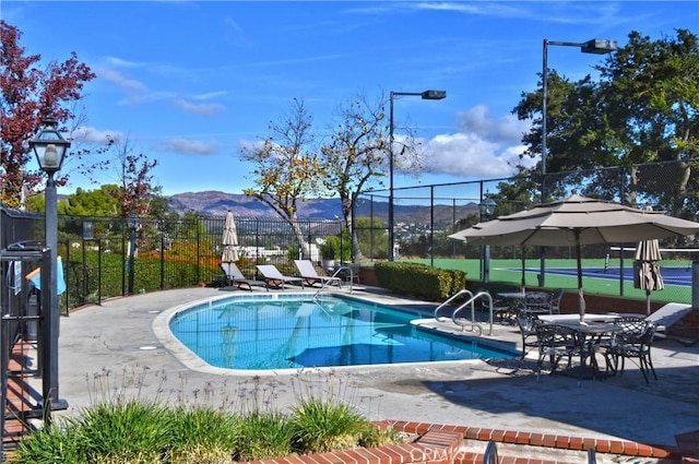 view of pool with a mountain view and a patio area