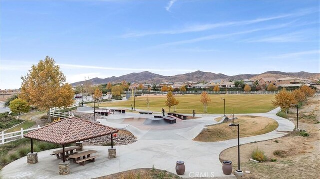 view of property's community with a gazebo, a mountain view, and a lawn