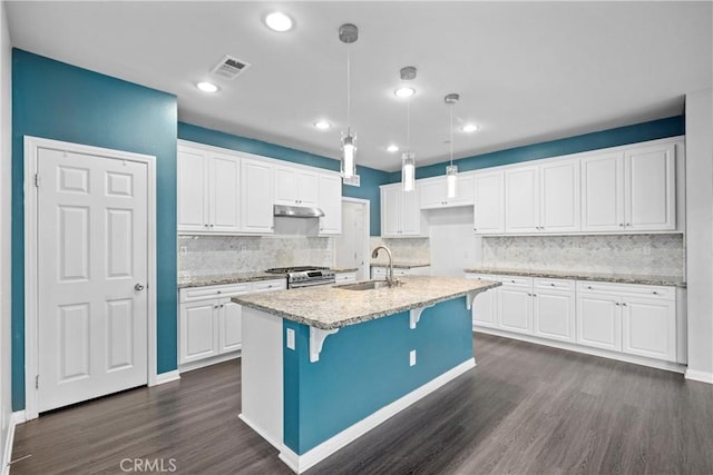 kitchen featuring dark hardwood / wood-style floors, white cabinetry, and sink