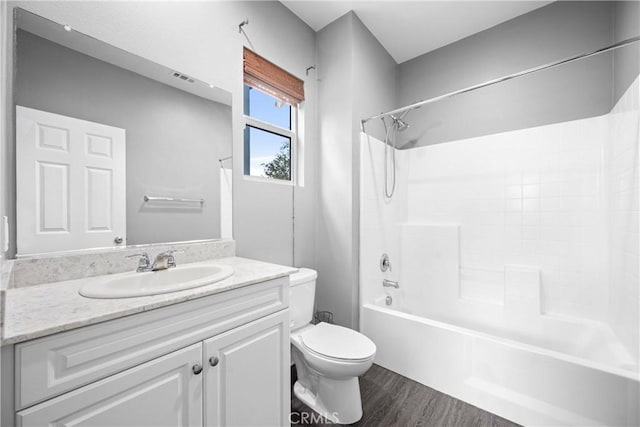 full bathroom with hardwood / wood-style flooring, vanity, toilet, and bathtub / shower combination