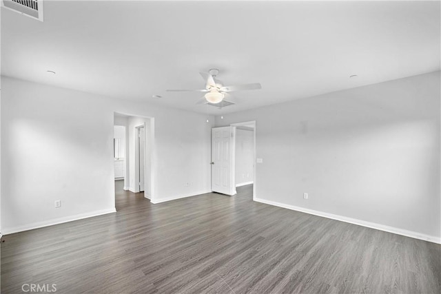 unfurnished room with dark hardwood / wood-style flooring and ceiling fan