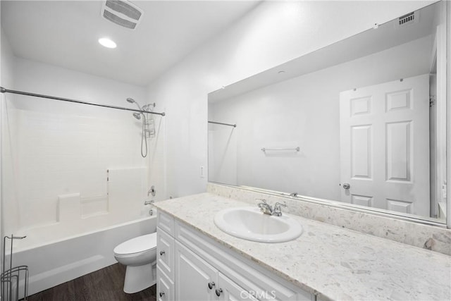 full bathroom with shower / tub combination, toilet, vanity, and hardwood / wood-style flooring