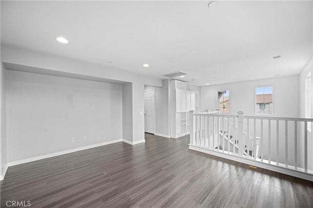 unfurnished room featuring dark hardwood / wood-style flooring