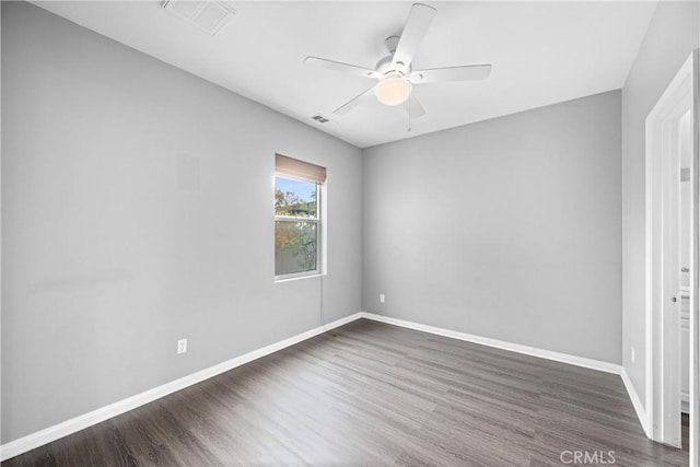 spare room featuring ceiling fan and dark hardwood / wood-style flooring