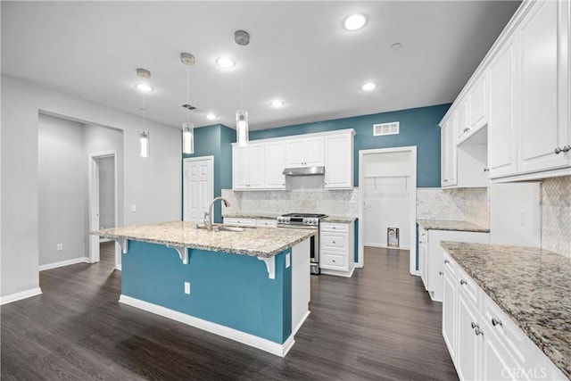 kitchen featuring white cabinetry, stainless steel gas stove, dark wood-type flooring, and sink