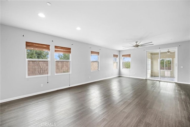 spare room featuring dark hardwood / wood-style flooring and ceiling fan