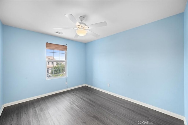 unfurnished room with ceiling fan and dark wood-type flooring