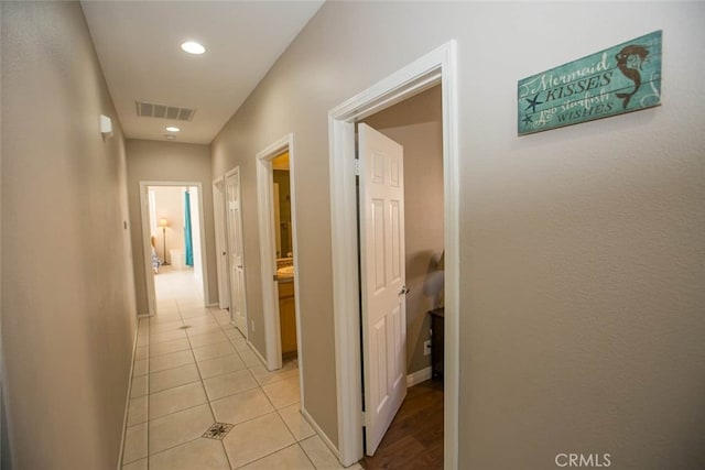 hallway featuring light tile patterned floors