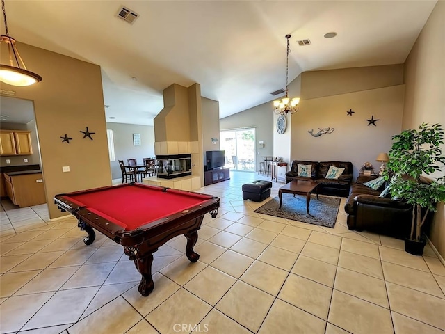 recreation room with light tile patterned flooring, vaulted ceiling, a fireplace, and pool table