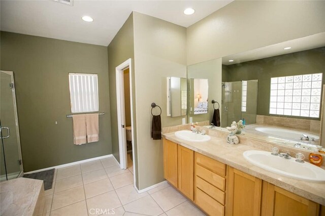 full bathroom featuring tile patterned flooring, vanity, toilet, and independent shower and bath