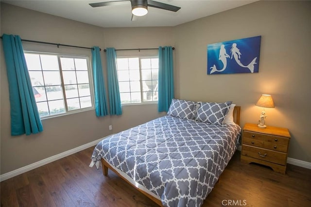 bedroom with ceiling fan and dark wood-type flooring