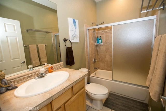 full bathroom featuring vanity, toilet, and bath / shower combo with glass door