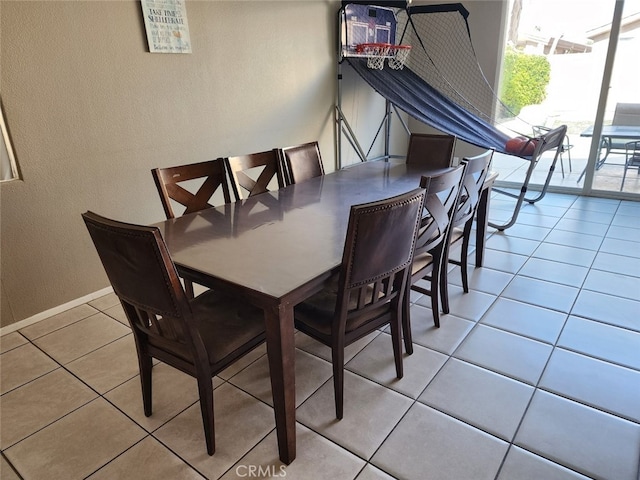 79534 Dandelion Dr, La Quinta, CA 92253 - dining space with tile patterned floors, a textured wall, and baseboards