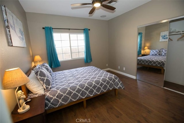 bedroom with ceiling fan, dark wood-type flooring, and a closet