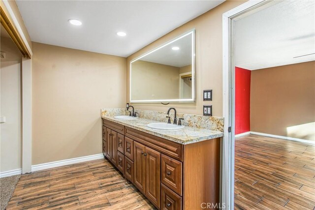 bathroom with vanity and wood-type flooring