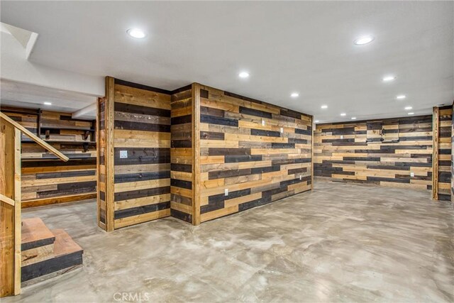 finished basement with stairs and recessed lighting