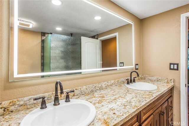 bathroom featuring vanity and an enclosed shower