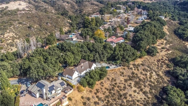 bird's eye view featuring a forest view and a residential view