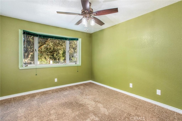 carpeted spare room with a ceiling fan, a textured wall, and baseboards