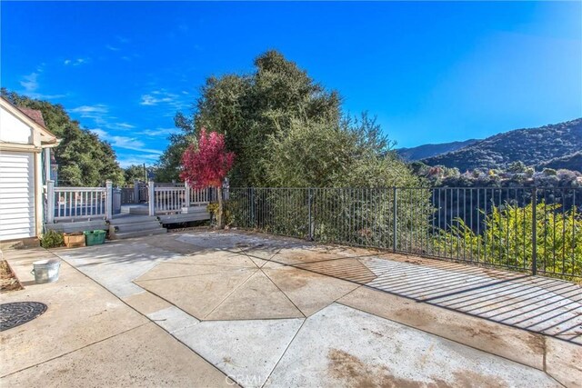 view of patio / terrace featuring a deck with mountain view