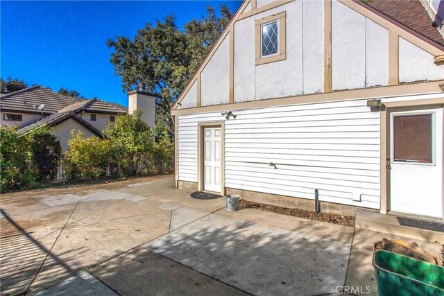 view of property exterior with a patio area