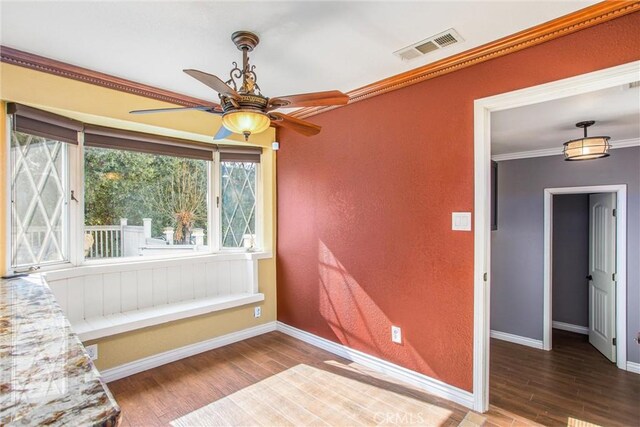 interior space with hardwood / wood-style floors and crown molding