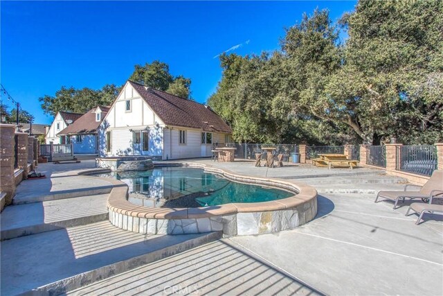 view of pool with a patio area and an outdoor structure