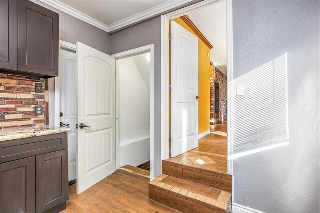 interior space featuring ornamental molding and light hardwood / wood-style floors