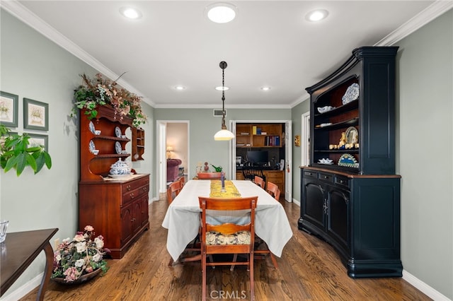 dining area with dark hardwood / wood-style floors and crown molding