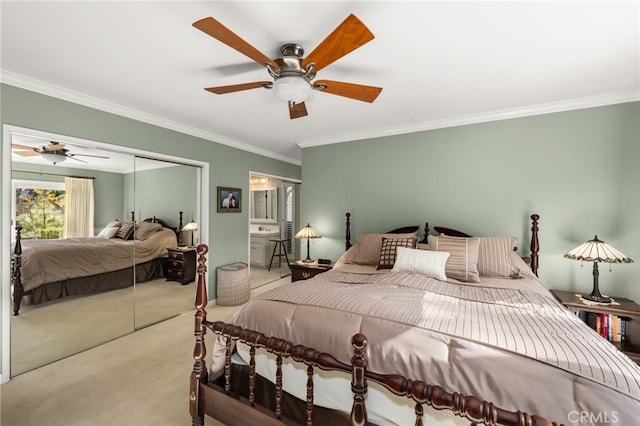 carpeted bedroom with ceiling fan, a closet, and ornamental molding