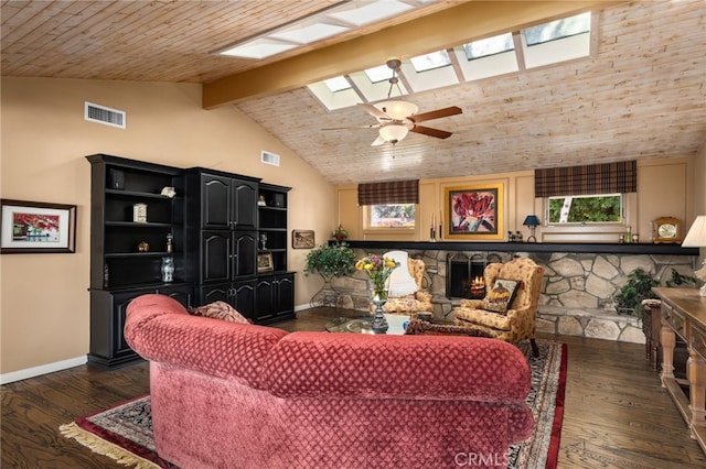 living room with vaulted ceiling with skylight, plenty of natural light, ceiling fan, and dark hardwood / wood-style floors