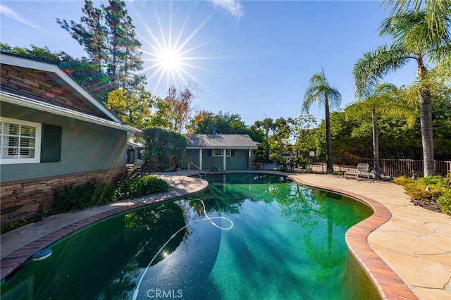 view of pool with a patio area, fence, and a fenced in pool