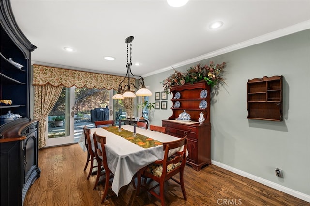 dining area with wood-type flooring and ornamental molding