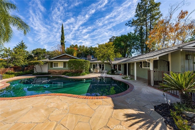 view of swimming pool featuring a fenced in pool, a patio area, and fence