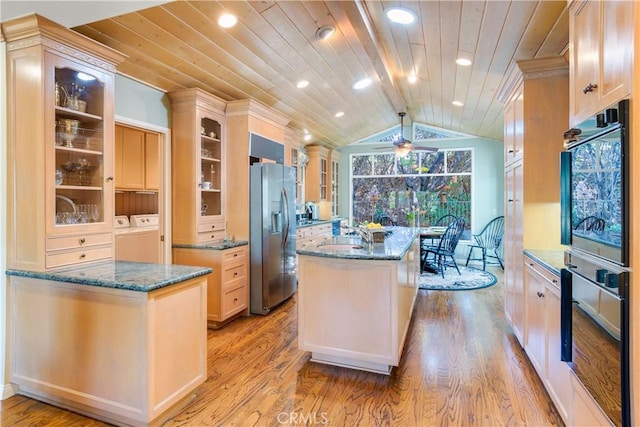 kitchen with light wood-type flooring, a kitchen island, stainless steel refrigerator with ice dispenser, wooden ceiling, and independent washer and dryer