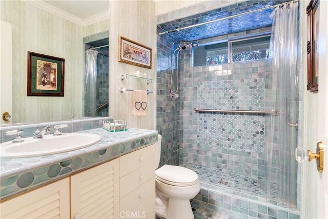 bathroom with toilet, wallpapered walls, a shower stall, crown molding, and vanity