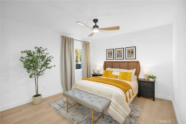 bedroom with ceiling fan and light hardwood / wood-style floors