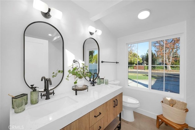 bathroom with lofted ceiling with beams, vanity, and toilet