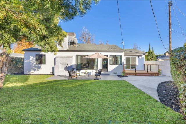 rear view of property featuring a patio, a yard, and an outdoor hangout area