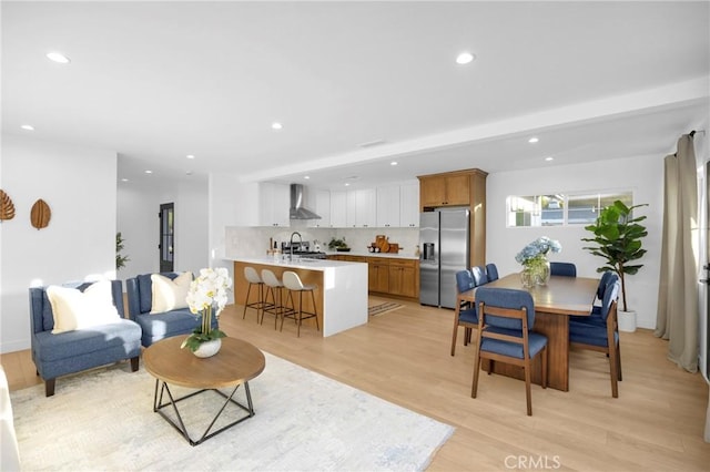 living room with sink and light hardwood / wood-style flooring