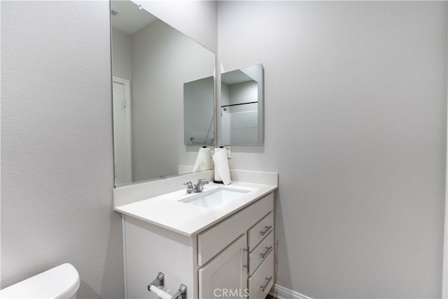 bathroom with vanity and toilet