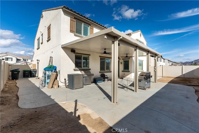 back of property featuring ceiling fan and a patio area