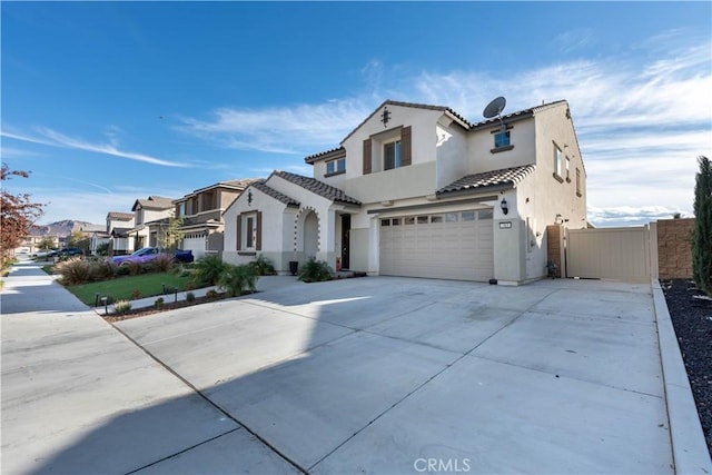 mediterranean / spanish-style home with a garage